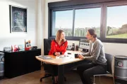 saleswoman speaking with a client in her office